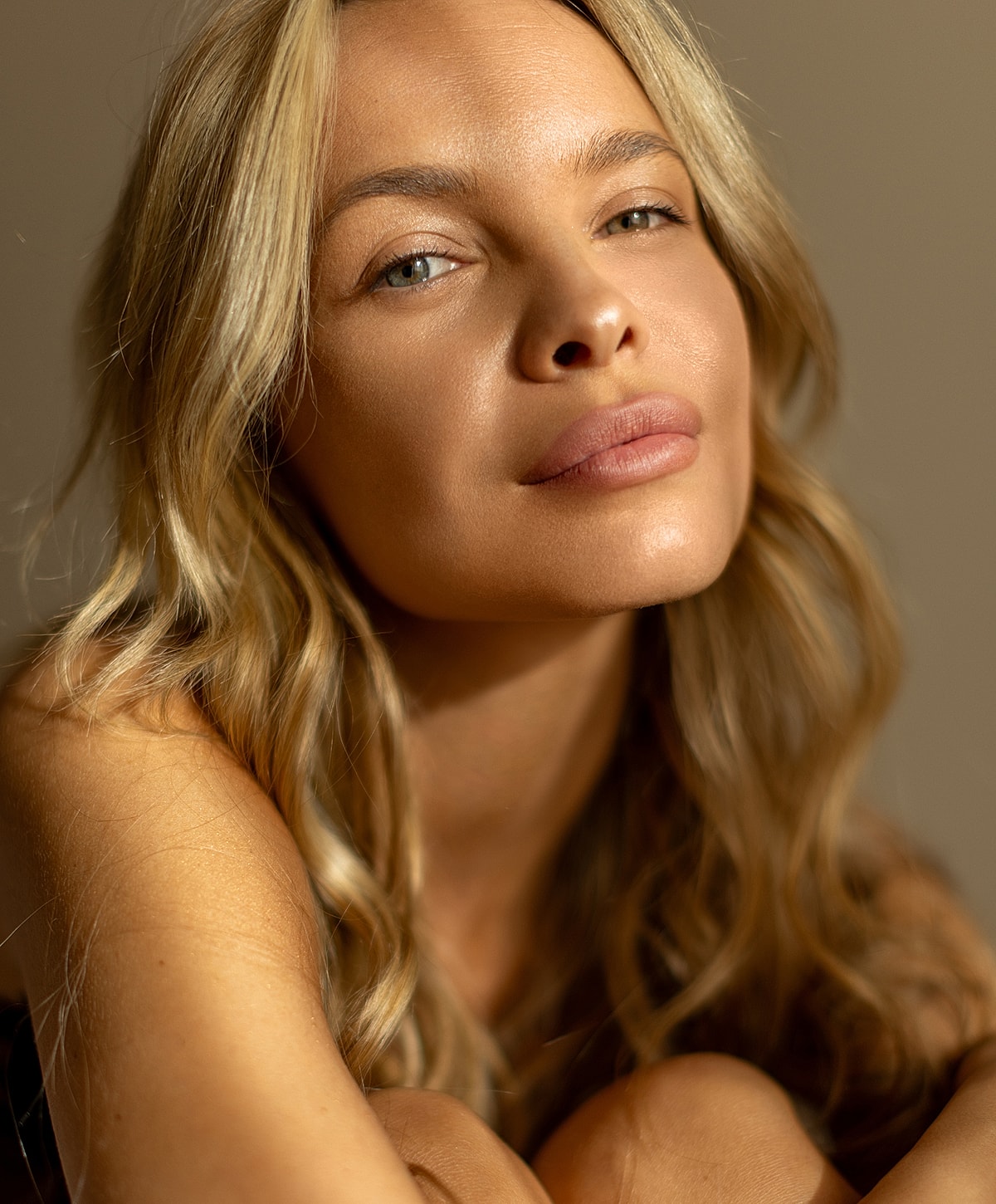 Close-up of a woman with soft, natural lighting.