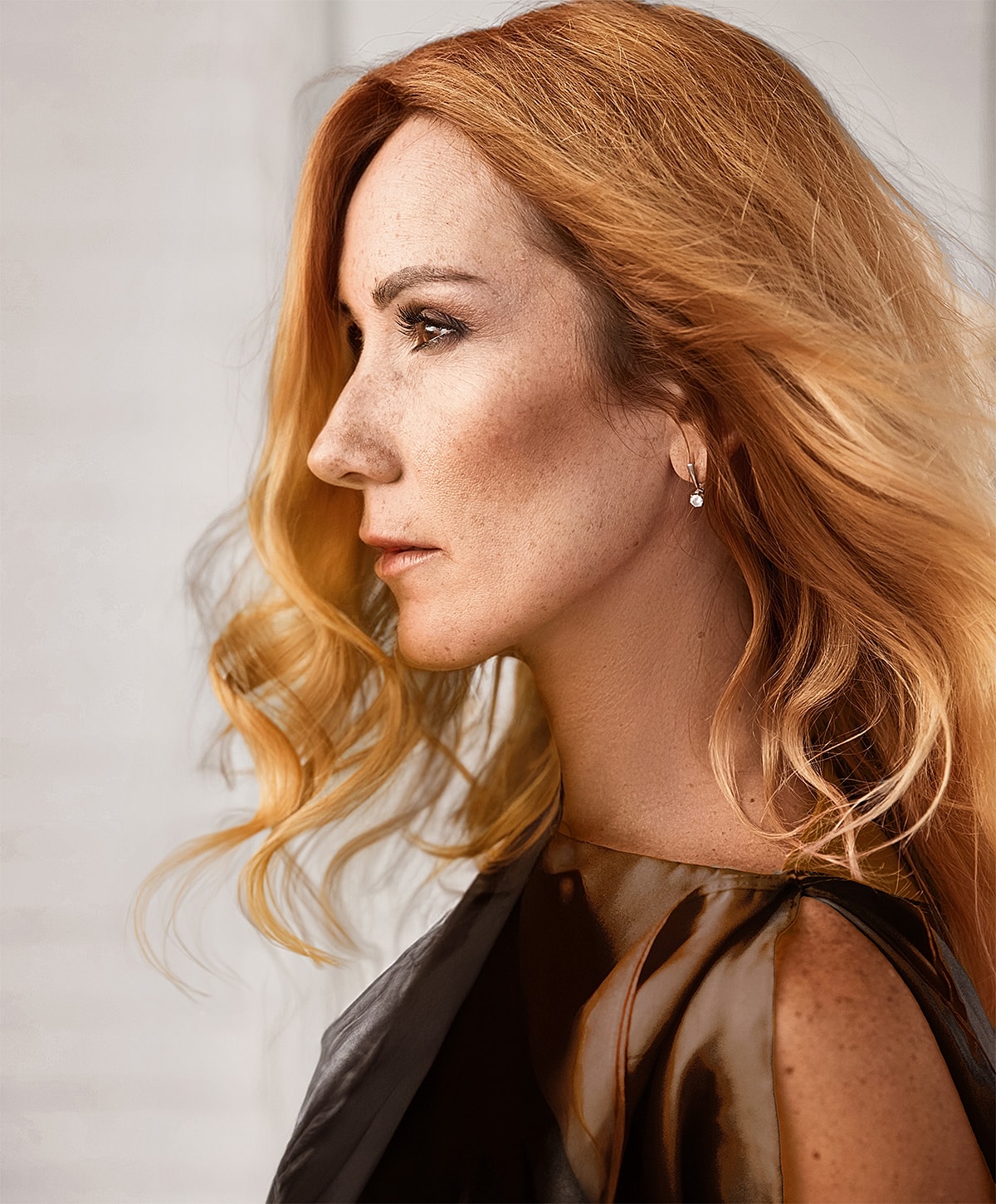 Profile of a woman with long, wavy hair.