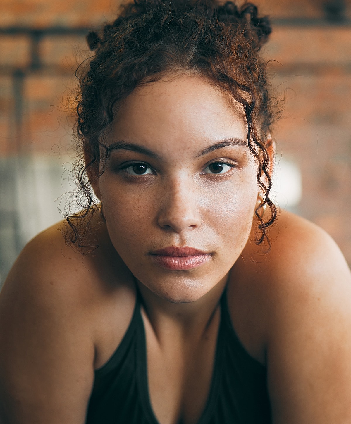 Close-up of young woman with curly hair.