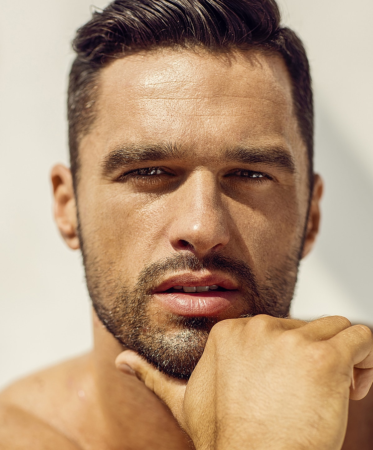 Close-up of a thoughtful man with stubble.