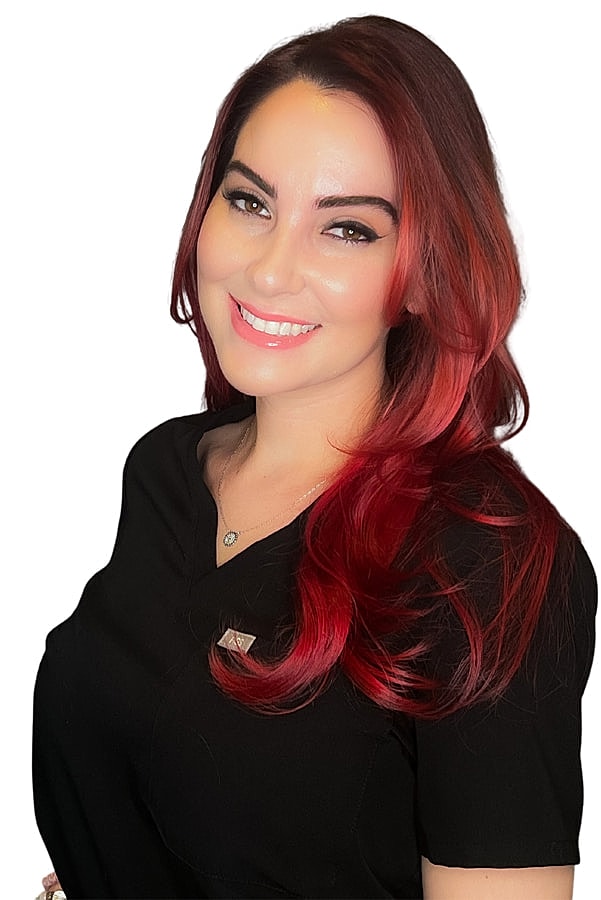 Smiling woman with red hair in black top.