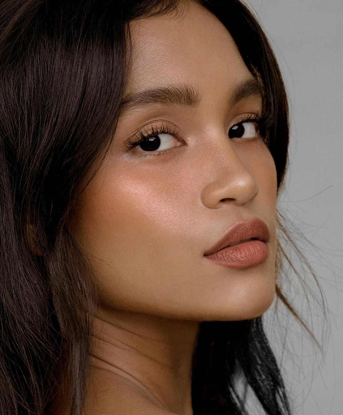 Portrait of a woman with glowing skin.
