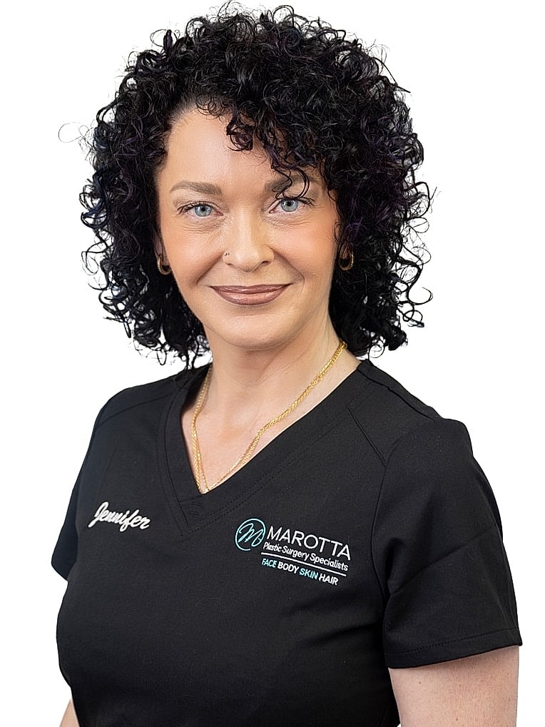 Woman with curly hair in professional attire.