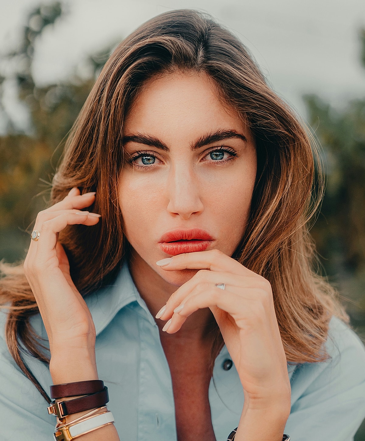 Woman with striking blue eyes and soft expression.