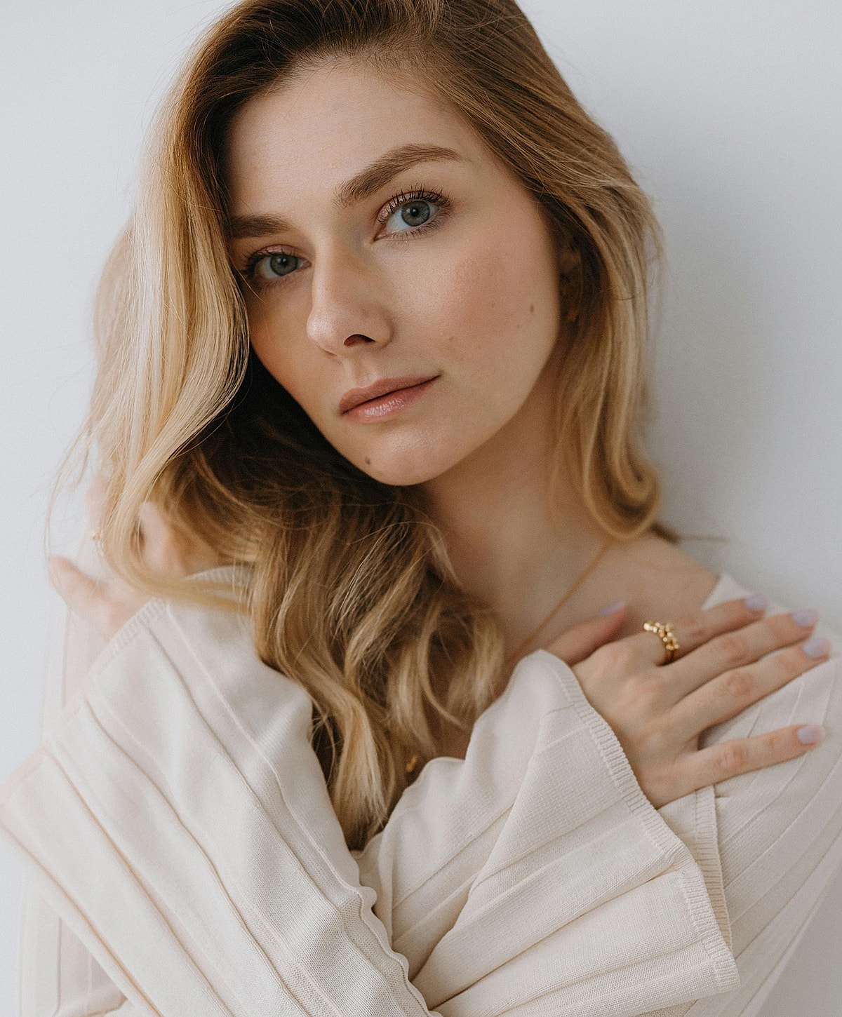 Woman with long hair posing thoughtfully.
