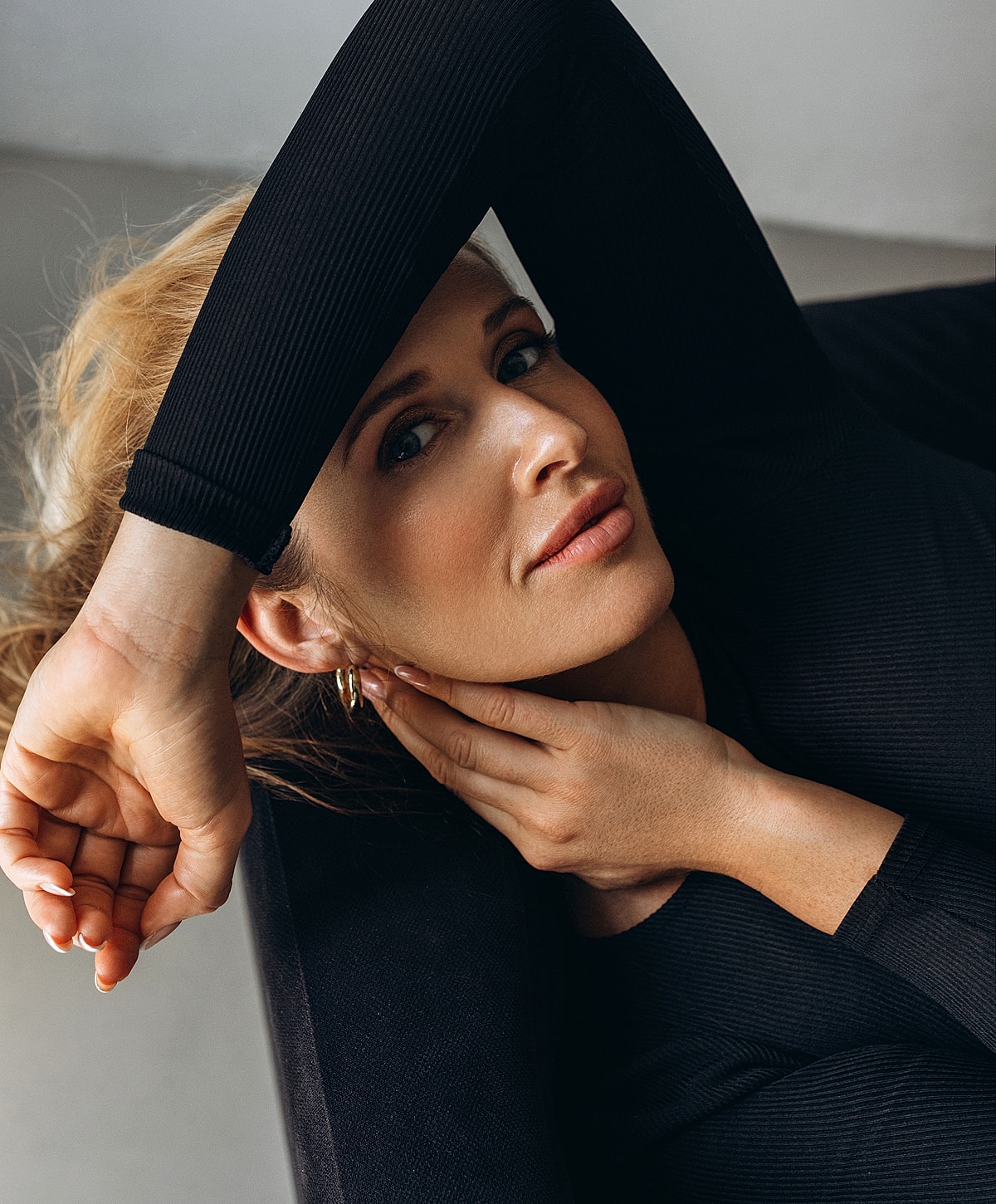 Woman resting with hand on her face.