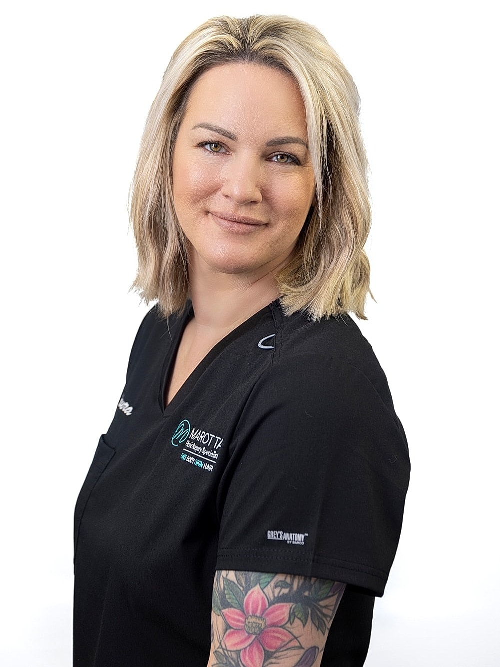 Healthcare professional smiling in black scrubs.