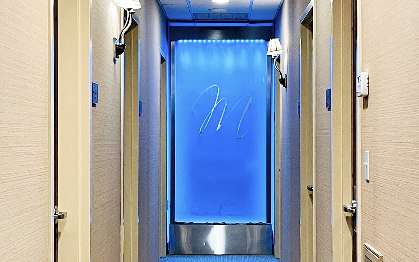 Modern hallway with blue lighting and decor