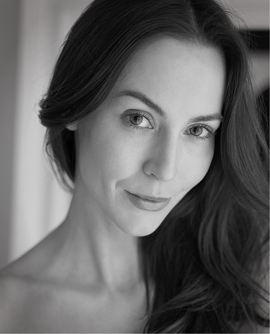 Close-up portrait of a woman in black and white.