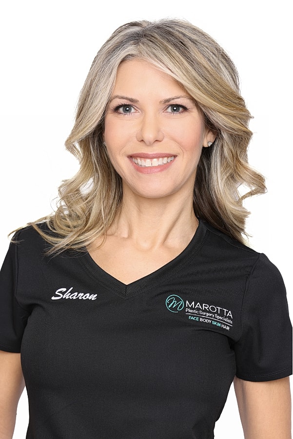 Professional woman wearing medical uniform and smiling