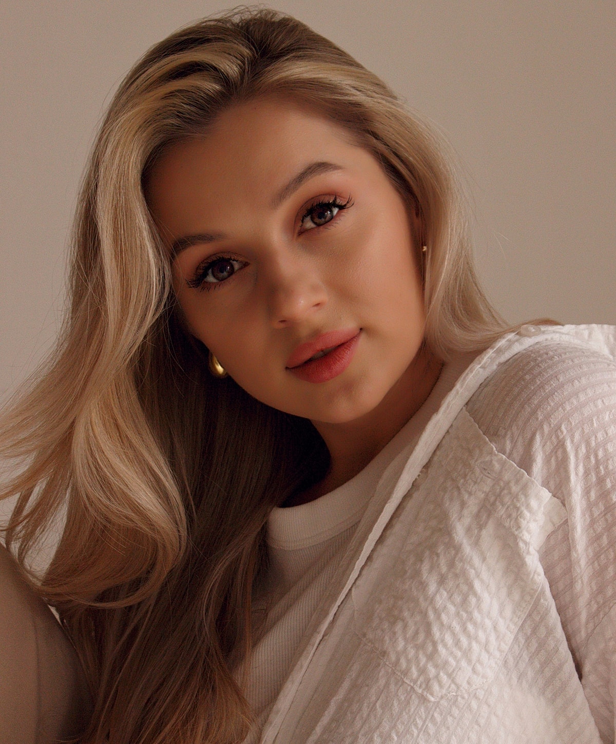 Woman with long blonde hair and soft expression.