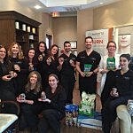 Team celebrating with awards in a clinic setting.