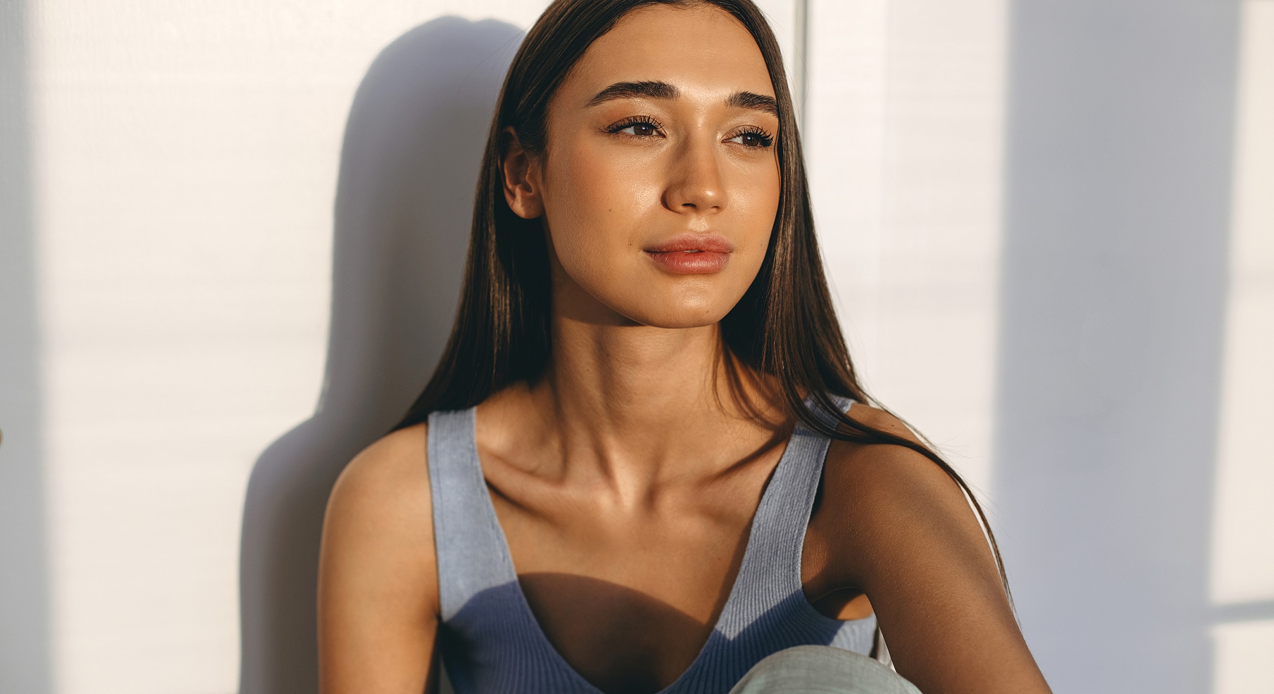 Young woman with long hair in natural light.