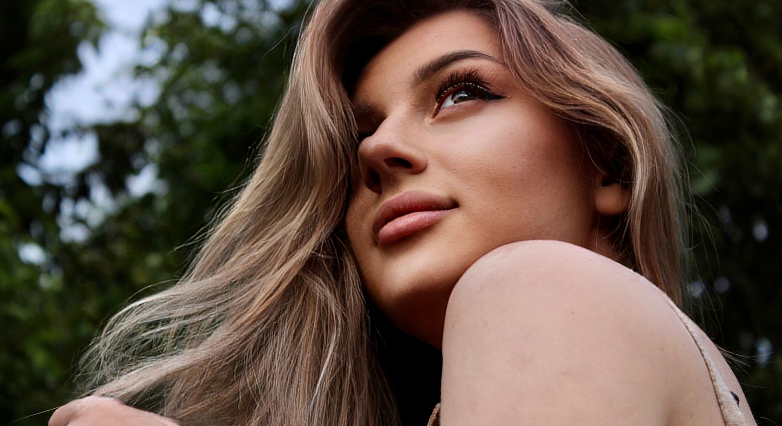 Portrait of a woman looking thoughtfully upward.